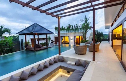 Luxury landscaped swimming pool surrounded by lush greenery